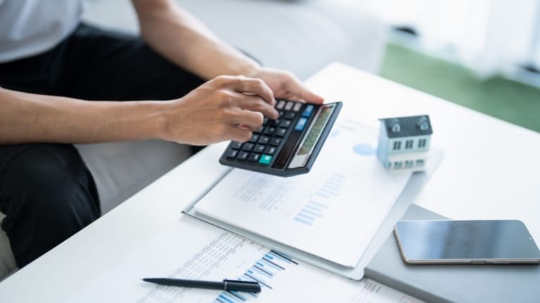 Real estate estate calculating his pay check